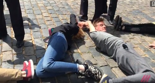 Участники акции "2036". Скриншот видео https://("Кавказский узел" может сообщить название организации по запросу).ru/news/na_krasnoj_ploschadi_aktivisty_vylozhili_telami_tsifru_2036_ih_zaderzhivajut-511648/