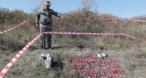 Сапер указывает на неразорвавшиеся кассетные бомбы, собранные после недавнего обстрела  на окраине Степанакерта. Фото: REUTERS/Stringer